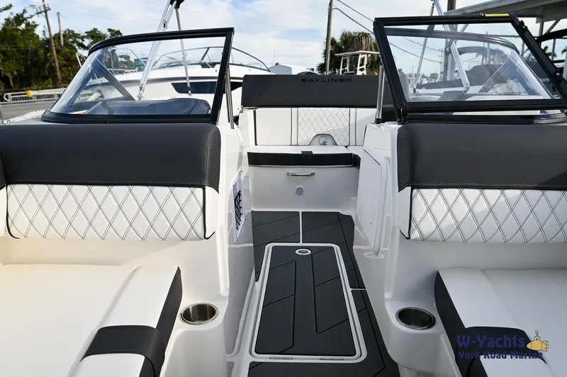 Slide: The Image of 2024 Bayliner DX2000 boat interior with black and white seating and modern design. - 7