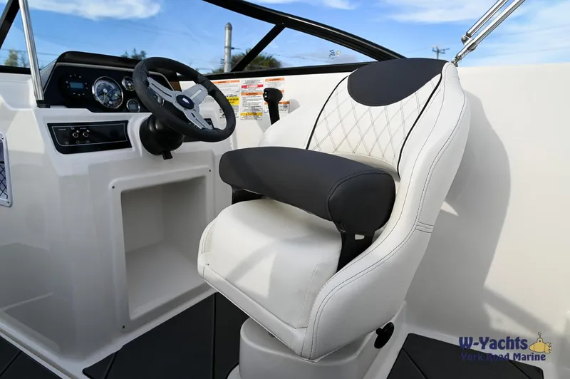Slide: The Image of 2024 Bayliner DX2000 boat cockpit with steering wheel and captain's chair. - 9
