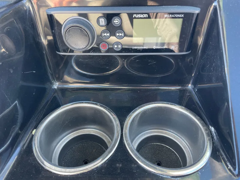 Slide: The Image of 2023 Wellcraft 222 Fisherman boat console with Fusion MS-RA70NSX stereo and dual cup holders. - 11