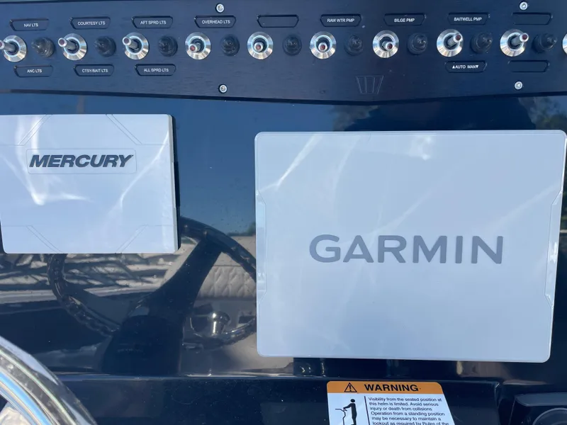 Slide: The Image of 2023 Wellcraft 222 Fisherman dashboard with Mercury and Garmin displays. - 12