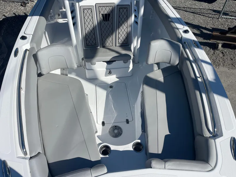 Slide: The Image of 2023 Wellcraft 222 Fisherman boat interior with cushioned seating and storage compartments. - 18
