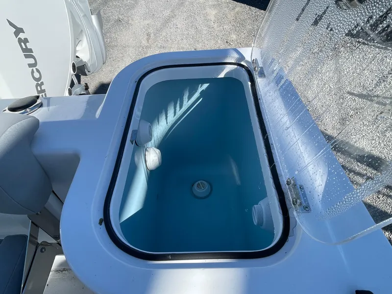 Slide: The Image of 2023 Wellcraft 222 Fisherman livewell with open lid and Mercury engine in background. - 23