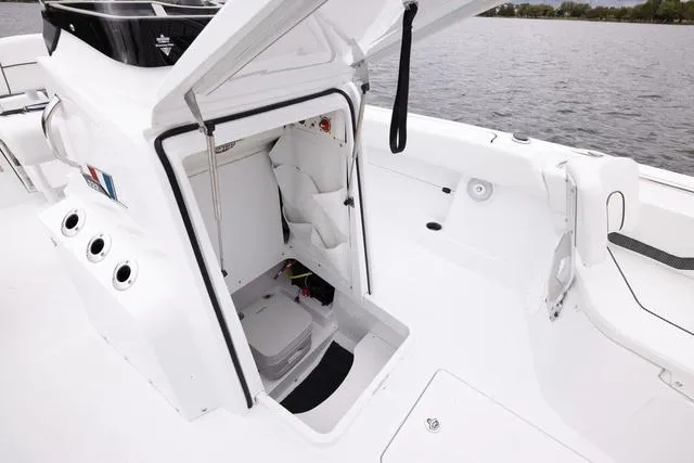 Slide: The Image of 2023 Wellcraft 222 Fisherman boat interior with open storage compartment. - 27