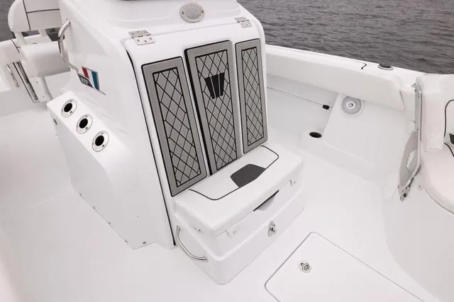Slide: The Image of 2023 Wellcraft 222 Fisherman boat interior, featuring storage compartments and rod holders. - 30
