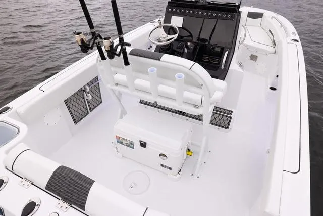 Slide: The Image of 2023 Wellcraft 222 Fisherman boat interior with fishing rod holders and steering console. - 33
