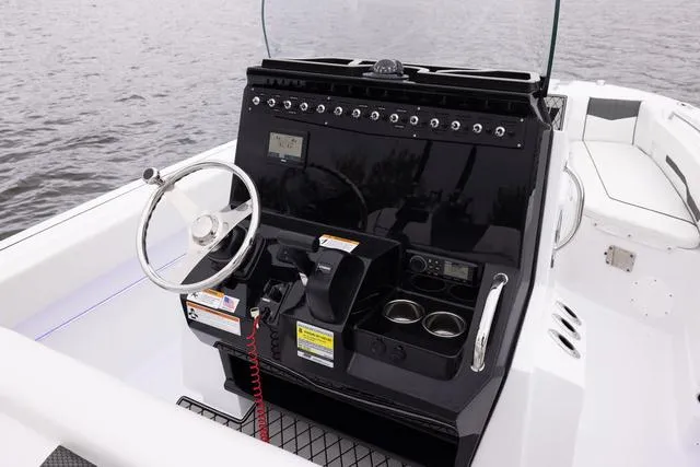 Slide: The Image of 2023 Wellcraft 222 Fisherman boat console with steering wheel and controls. - 39
