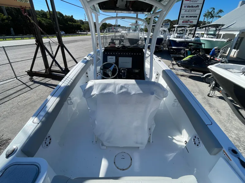 Slide: The Image of 2023 Wellcraft 222 Fisherman boat interior, featuring helm and seating area. - 4