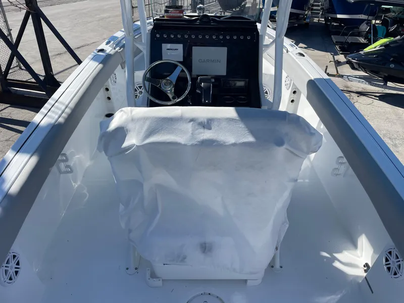 Slide: The Image of 2023 Wellcraft 222 Fisherman boat cockpit with covered seat and Garmin navigation system. - 5