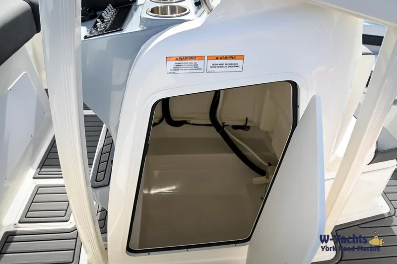 Slide: The Image of 2024 Bayliner T20 boat interior storage compartment with open door. - 10