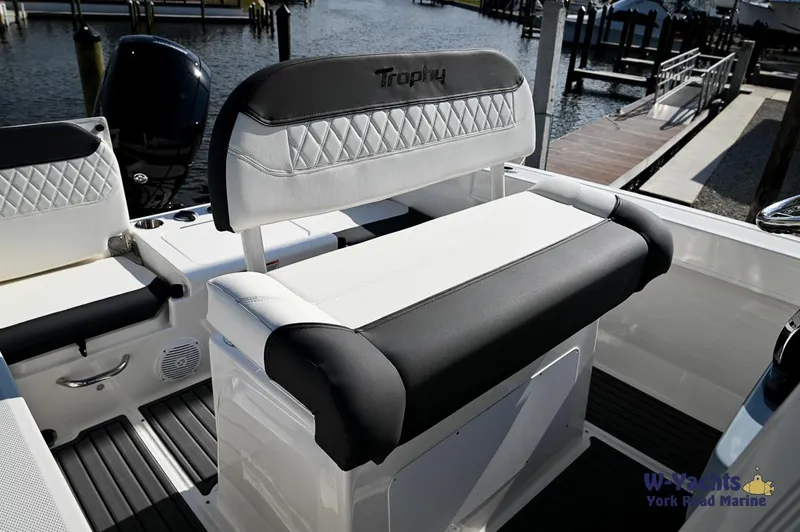 Slide: The Image of 2024 Bayliner T20 boat interior with cushioned seating at the dock. - 11
