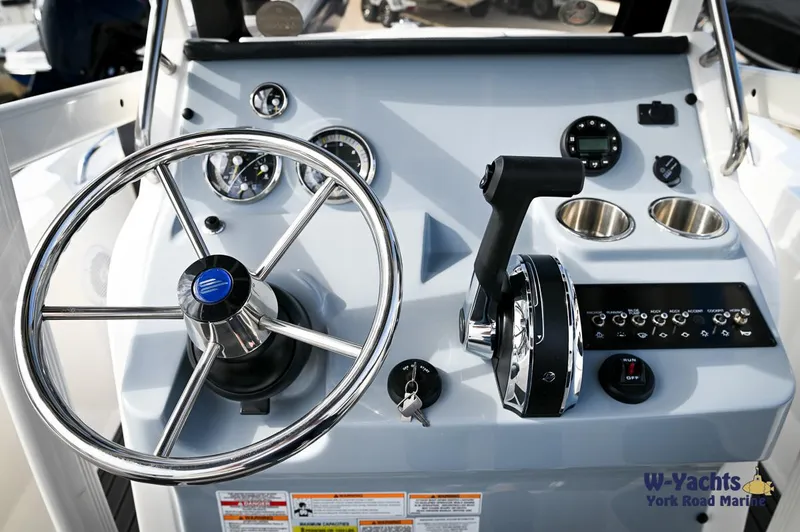 Slide: The Image of 2024 Bayliner T20 boat dashboard with steering wheel and control panel. - 13