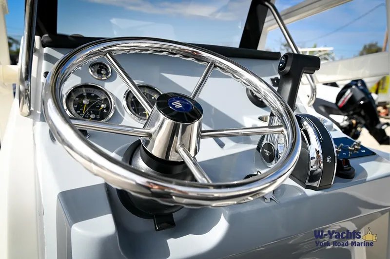 Slide: The Image of 2024 Bayliner T20 boat steering wheel and dashboard controls. - 14