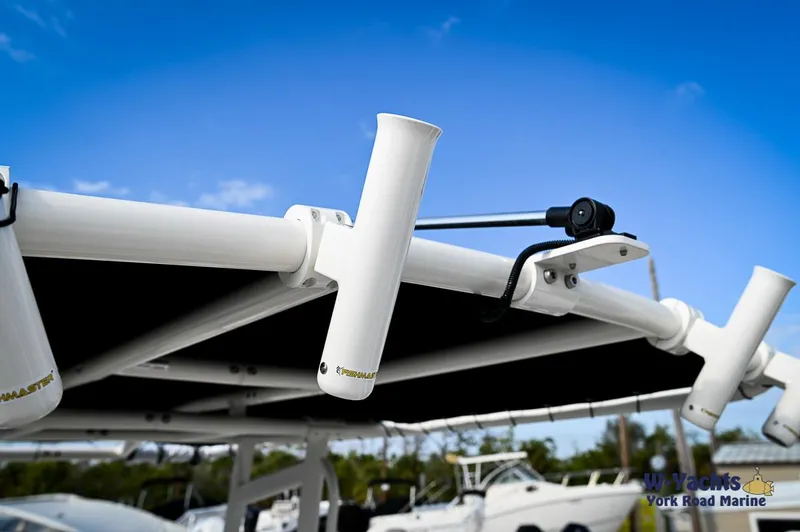 Slide: The Image of Close-up of 2024 Bayliner T20 boat's rod holders and canopy frame. - 19