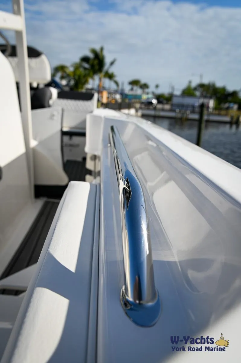 Slide: The Image of 2024 Bayliner T20 boat railing with marina background. - 32