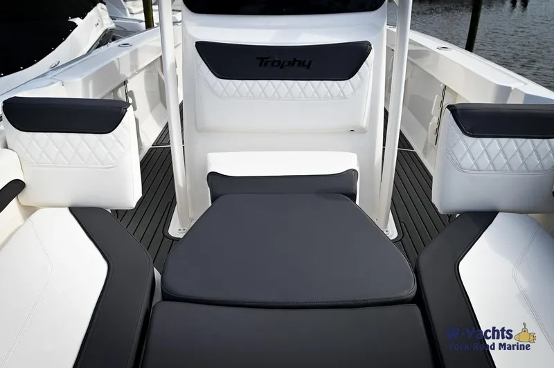 Slide: The Image of 2024 Bayliner T20 boat interior with cushioned seating and Trophy branding. - 7