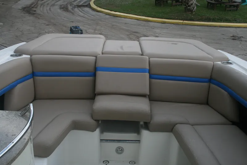 Slide: The Image of 2014 Sea Ray 270 SLX boat with beige and blue cushioned seating. - 11