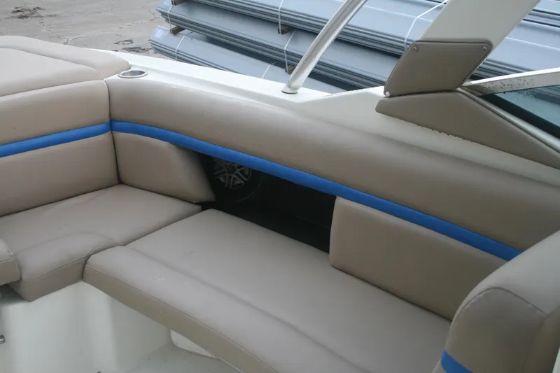 Slide: The Image of 2014 Sea Ray 270 SLX boat interior seating with beige and blue upholstery. - 12