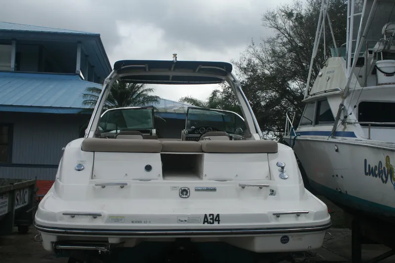 Slide: The Image of 2014 Sea Ray 270 SLX boat docked near other vessels. - 2