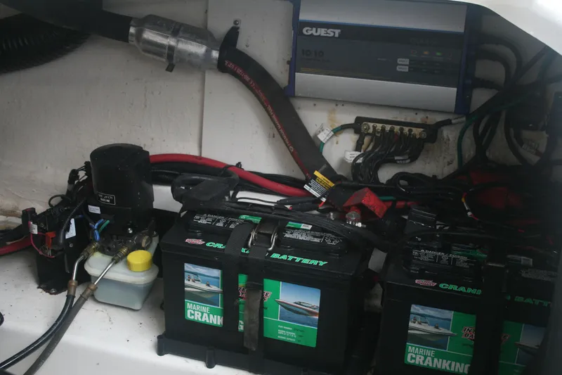 Slide: The Image of 2014 Sea Ray 270 SLX boat battery compartment with marine cranking batteries and wiring. - 27
