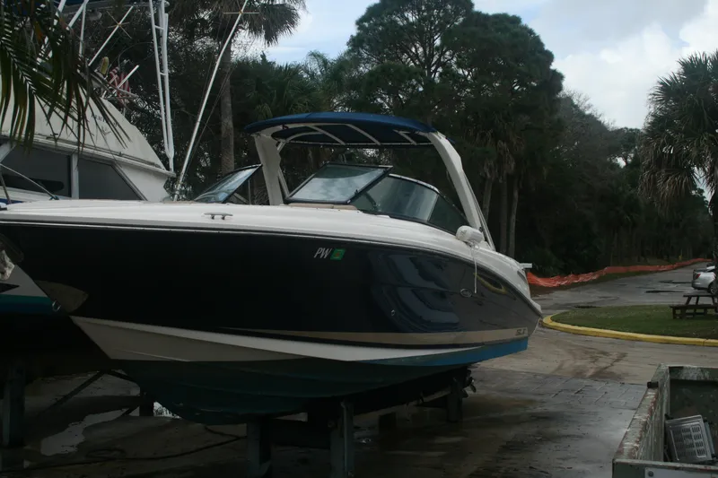 Slide: The Image of 2014 Sea Ray 270 SLX boat on a trailer in a marina. - 30