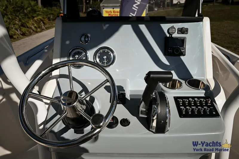 Slide: The Image of 2023 Bayliner T24 boat dashboard with steering wheel and control panel. - 10