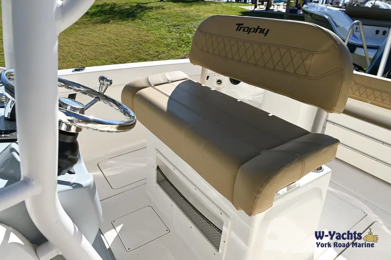 Slide: The Image of 2023 Bayliner T24 boat interior with tan seating and steering wheel. - 12