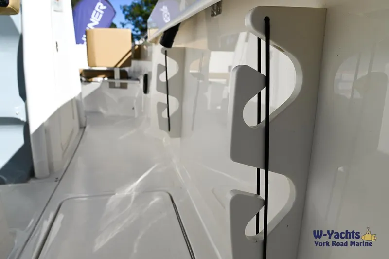 Slide: The Image of 2023 Bayliner T24 boat interior with rod holders, displayed at W-Yachts York Road Marine. - 20