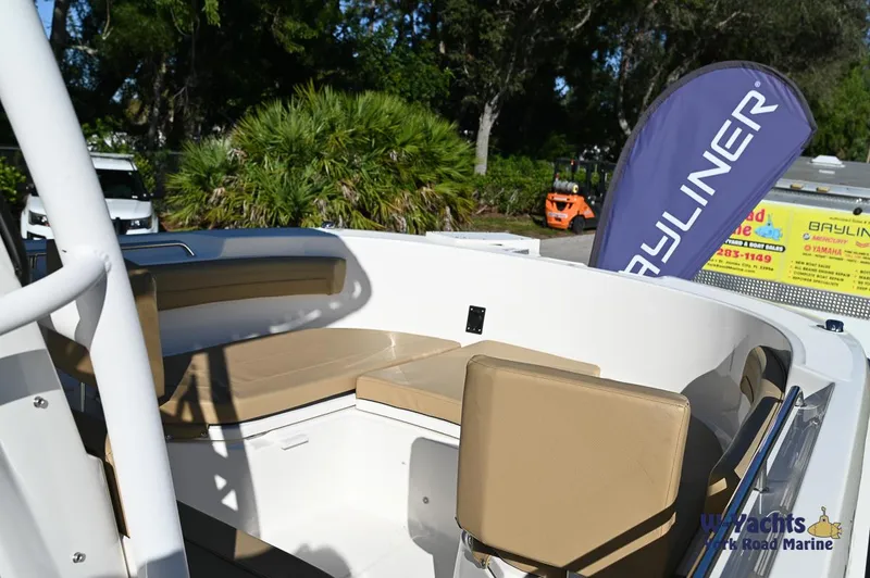 Slide: The Image of 2023 Bayliner T24 boat interior with tan seating and Bayliner flag. - 7