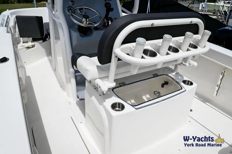 Slide: The Image of 2023 Bayliner T24 boat interior with rod holders and steering console. - 11