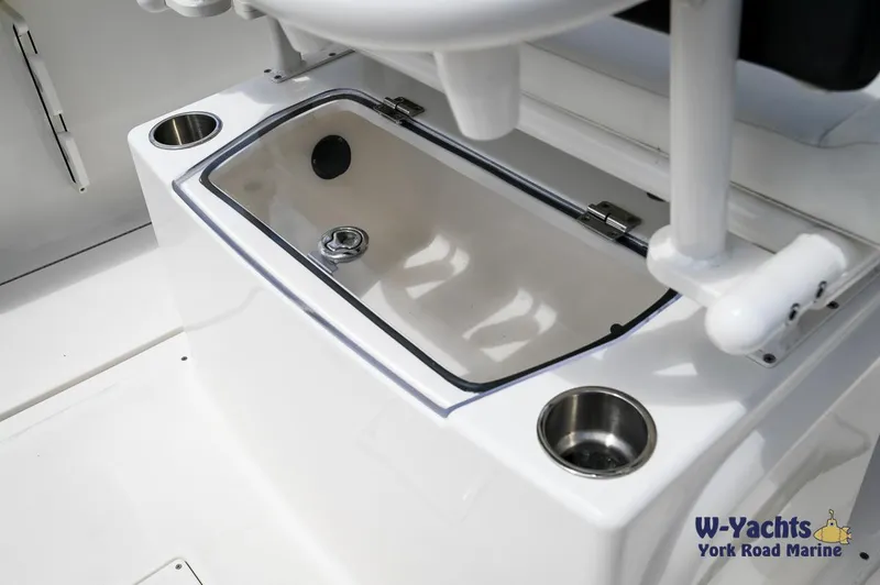 Slide: The Image of Bayliner T24 2023 boat interior with storage compartment and cup holders. - 17