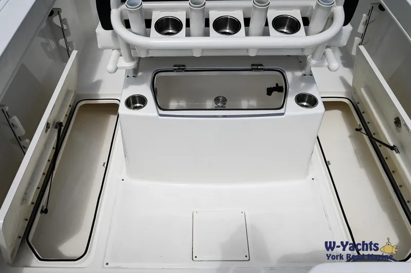 Slide: The Image of 2023 Bayliner T24 boat interior with storage compartments and rod holders. - 18