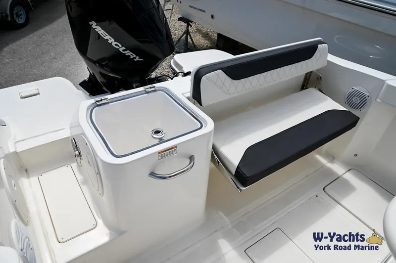 Slide: The Image of 2023 Bayliner T24 boat interior with seating and Mercury outboard motor. - 21