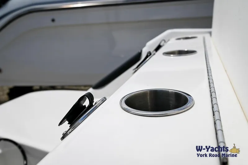 Slide: The Image of 2023 Bayliner T24 boat deck with cup holders and rod holders. - 28