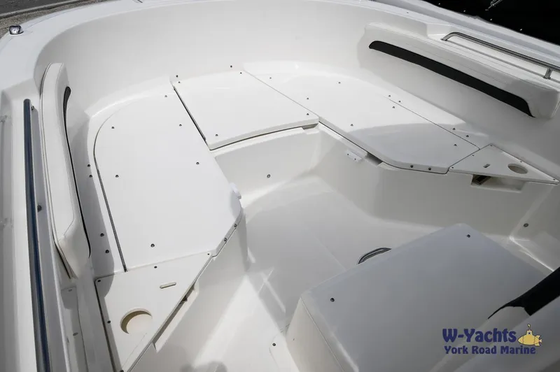 Slide: The Image of 2023 Bayliner T24 boat interior with white seating and storage compartments. - 7
