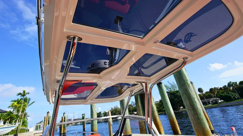 Slide: The Image of 2024 Nimbus Tender 8 #281 boat canopy with blue sky and waterfront view. - 12