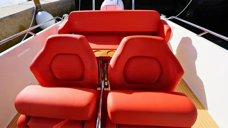 Slide: The Image of Red seating on 2024 Nimbus Tender 8 #281 boat, docked in sunlight. - 14