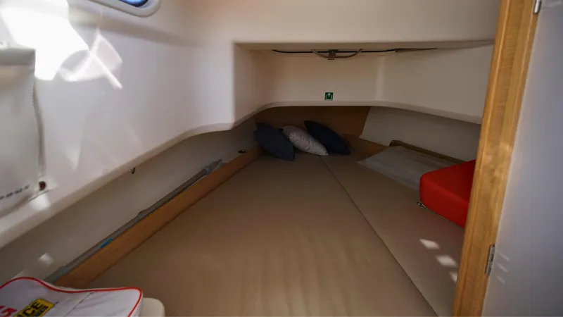 Slide: The Image of Cozy cabin interior of 2024 Nimbus Tender 8 boat with cushions and bedding. - 15