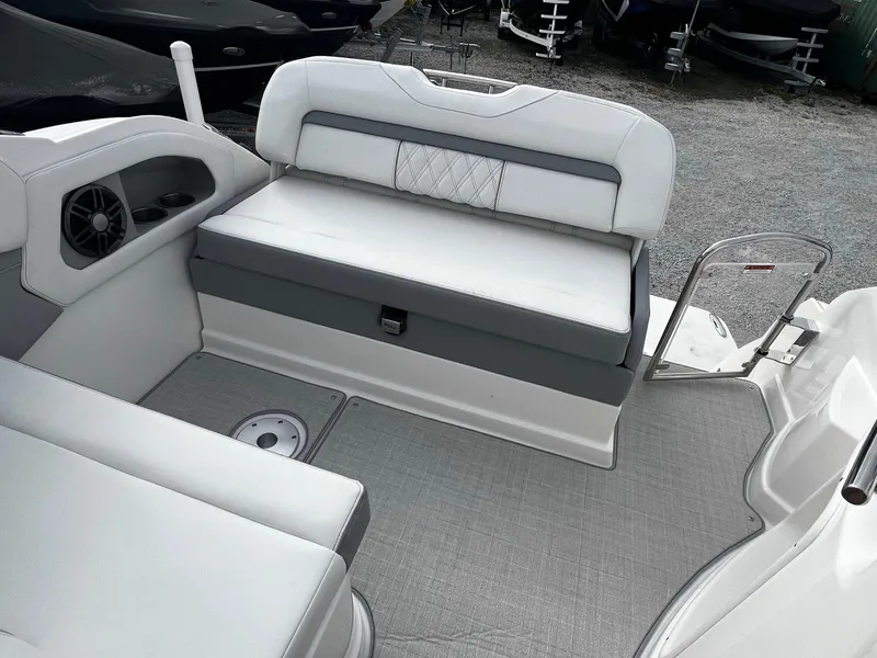 Slide: The Image of 2024 Regal 28 Express boat interior seating area with white and gray upholstery. - 11