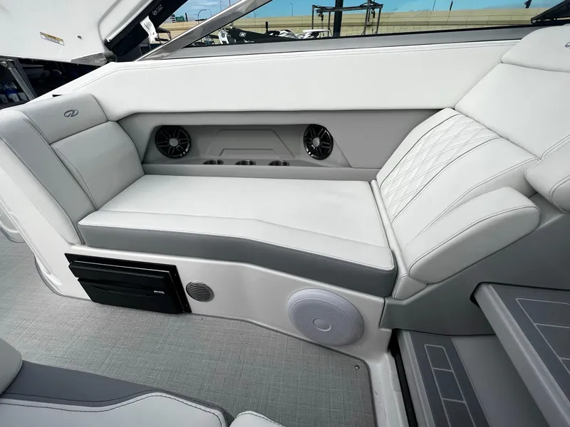 Slide: The Image of 2024 Regal 28 Express boat interior with white and gray seating. - 12