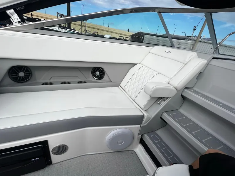 Slide: The Image of 2024 Regal 28 Express boat interior with white leather seating and modern amenities. - 13