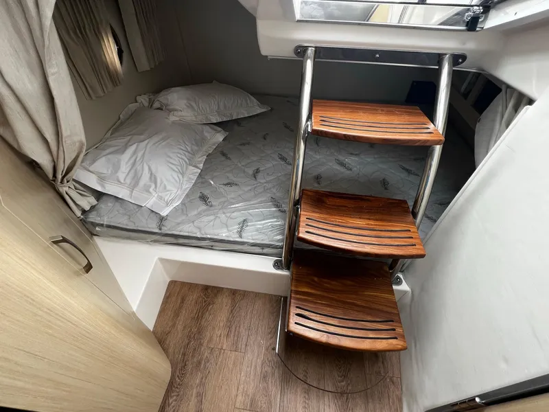 Slide: The Image of 2024 Regal 28 Express cabin interior with wooden steps and bed. - 18