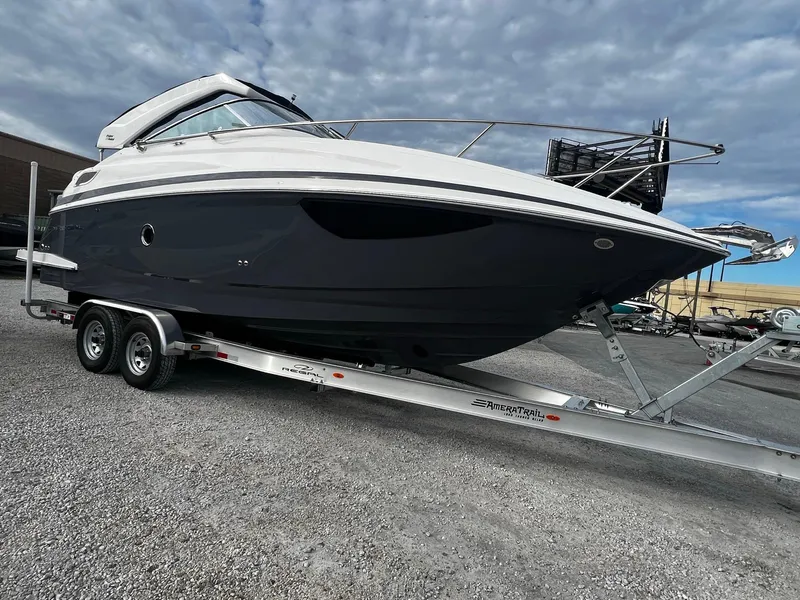Slide: The Image of 2024 Regal 28 Express boat on trailer under cloudy sky. - 2
