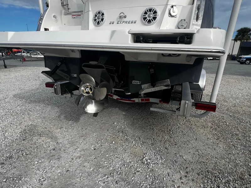 Slide: The Image of 2024 Regal 28 Express boat stern with dual propellers and trim tabs. - 4