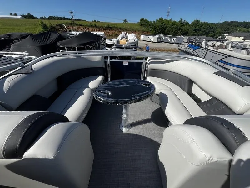 Slide: The Image of 2024 Sylvan Mirage 8524 LZ pontoon boat with spacious seating and central table. - 3