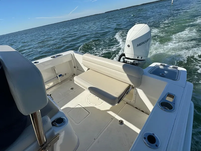 Slide: The Image of 2022 Boston Whaler 230 Outrage boat with Mercury outboard motor on open water. - 13