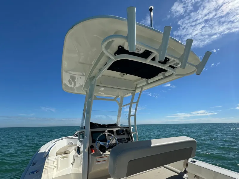 Slide: The Image of 2022 Boston Whaler 230 Outrage boat on open water under clear blue sky. - 15