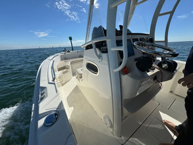 Slide: The Image of 2022 Boston Whaler 230 Outrage boat on open water under clear sky. - 16