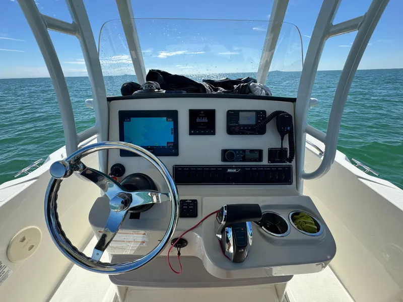 Slide: The Image of 2022 Boston Whaler 230 Outrage boat console with steering wheel and navigation equipment. - 18