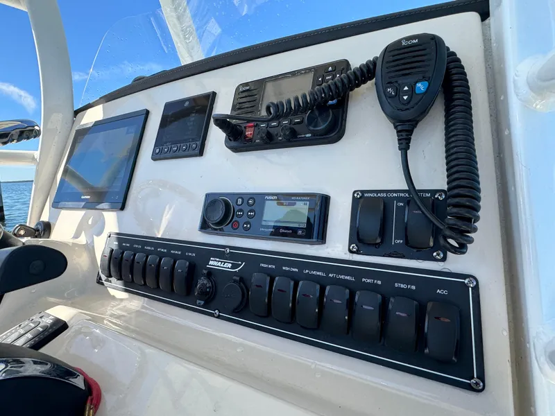 Slide: The Image of Control panel of a 2022 Boston Whaler 230 Outrage boat with navigation and communication equipment. - 19