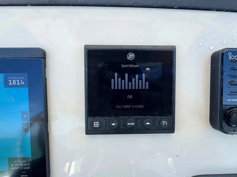 Slide: The Image of Control panel of a 2022 Boston Whaler 230 Outrage boat showing sport exhaust settings. - 23